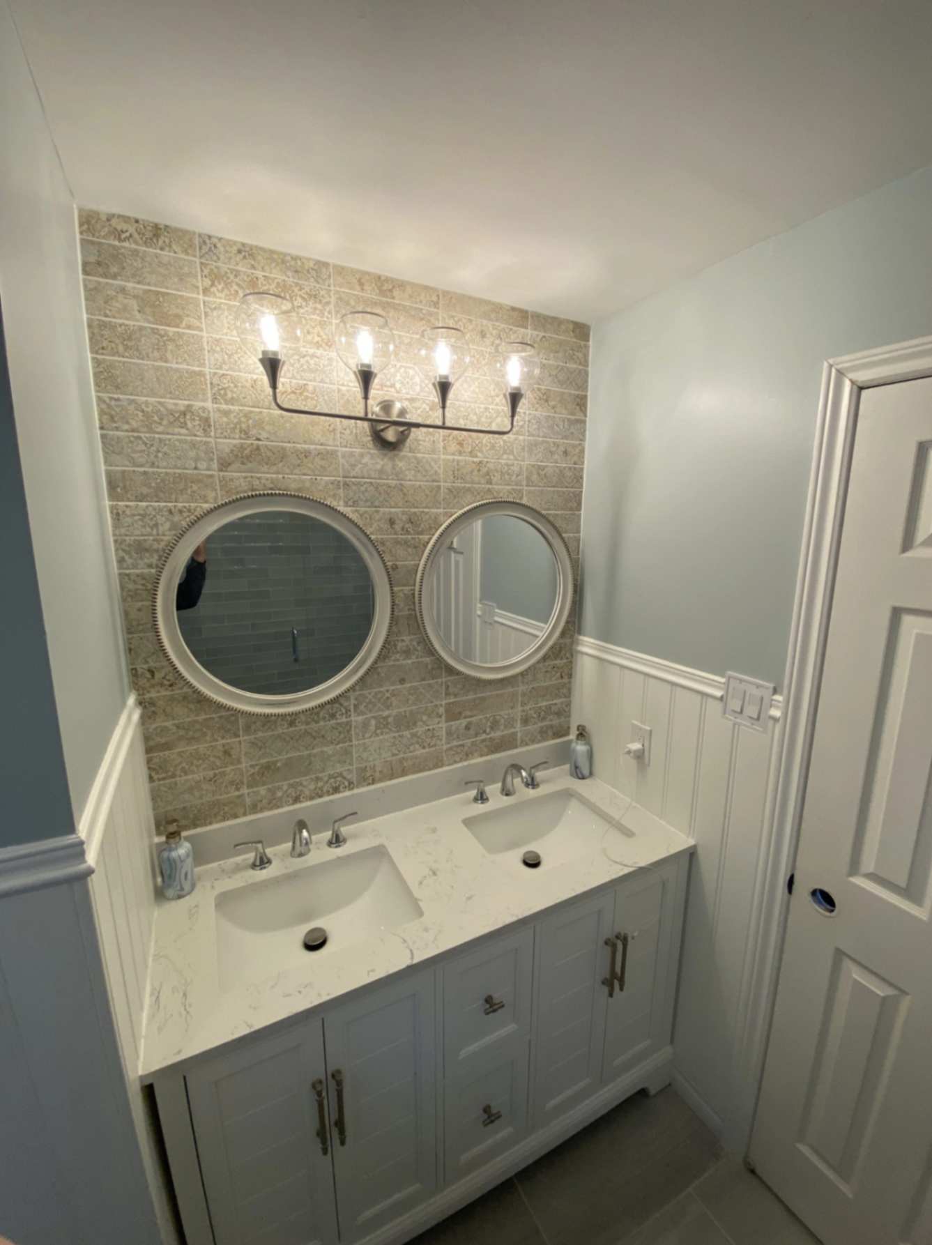 Modern bathroom renovation with vanity and wainscoting